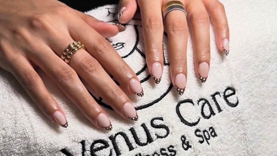 Stylish manicured hands display nail art on Venus Care towel in Riyadh, Riyadh Province, SA.