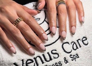 Stylish manicured hands display nail art on Venus Care towel in Riyadh, Riyadh Province, SA.