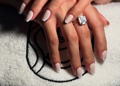 Close-up of French manicure at Venus Care, Riyadh, Riyadh Province, SA, highlighting elegant nails.