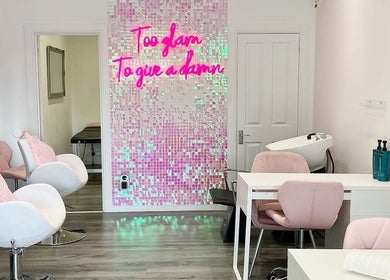 Chic interior of Make A Wish Beauty in Glasgow, Scotland, featuring stylish seating and neon decor.