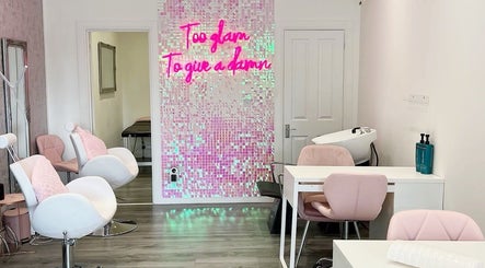 Chic interior of Make A Wish Beauty in Glasgow, Scotland, featuring stylish seating and neon decor.