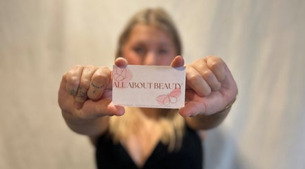 Person holding All About Beauty Salon card in Eagan, Minnesota, US.