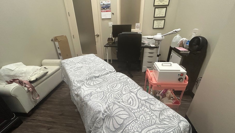 Serene treatment room at All About Beauty Salon, Eagan, Minnesota, US, featuring a cozy massage bed.