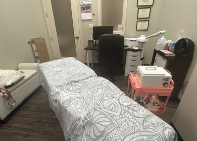 Serene treatment room at All About Beauty Salon, Eagan, Minnesota, US, featuring a cozy massage bed.