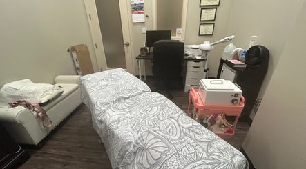 Serene treatment room at All About Beauty Salon, Eagan, Minnesota, US, featuring a cozy massage bed.