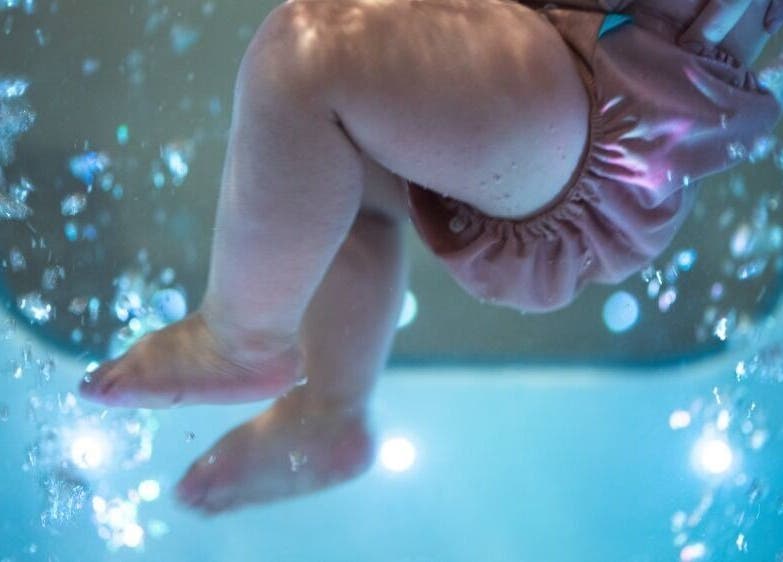 Baby in water at Leteau in Bristol, England, GB, enjoying a serene float experience.