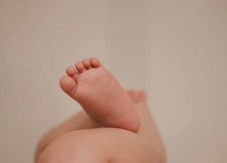 Close-up of a child's foot at Leteau spa, Bristol, England, GB, highlighting relaxation and wellness.