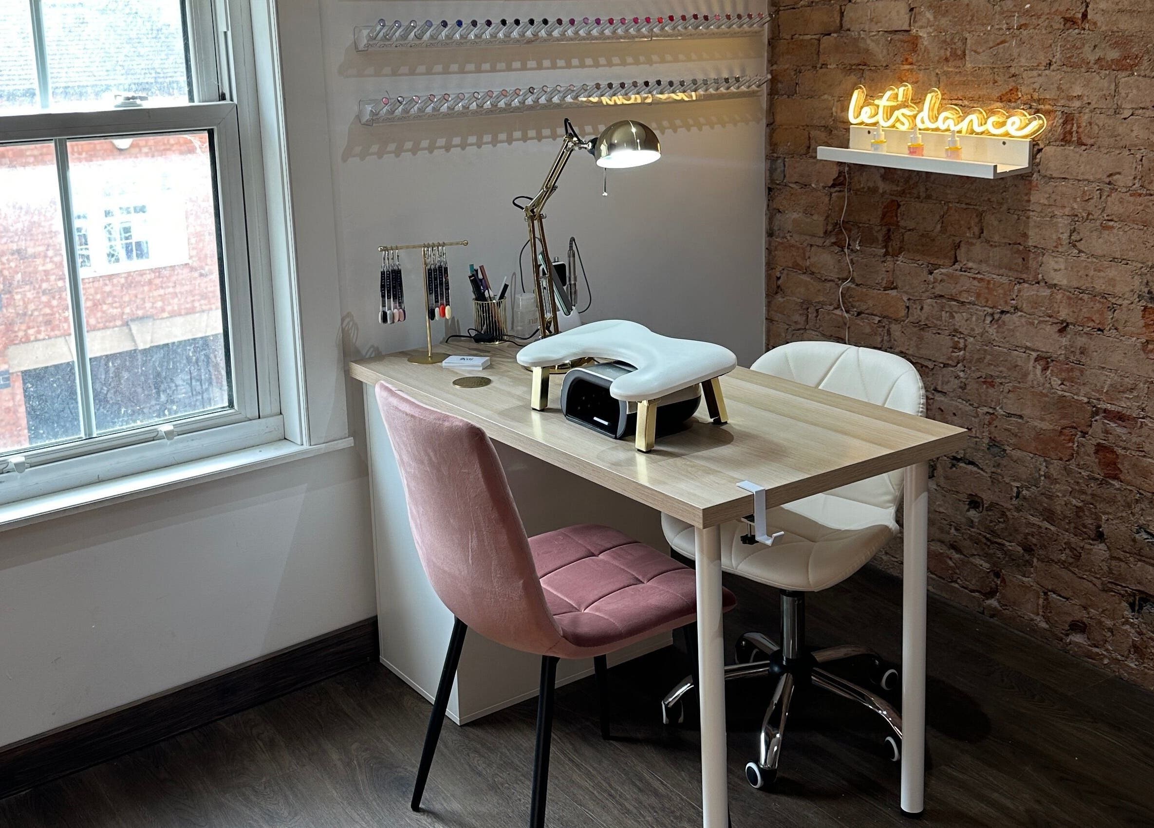 Cozy nail salon workspace at Nails By Kay, Bromsgrove, England, GB with rustic brick wall and elegant decor.