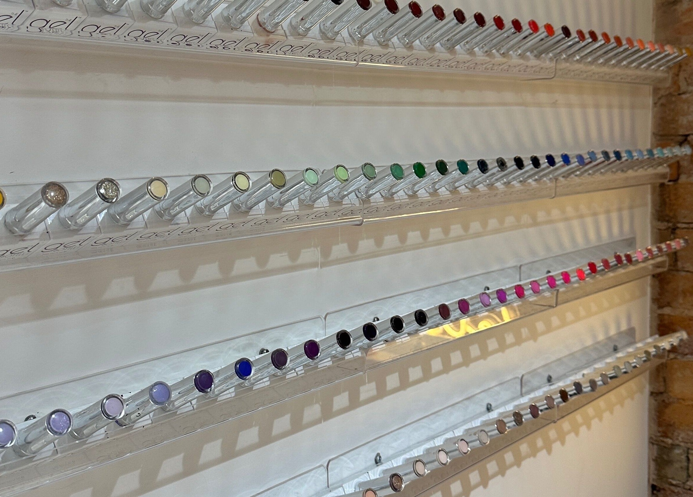 Vibrant nail polish collection at Nails By Kay in Bromsgrove, England, GB, showcasing diverse colors neatly organized.