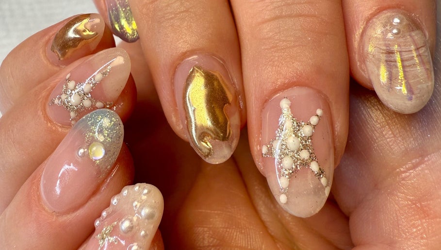 Intricate gold and pearl nail art at Jada Ellize Nails, London, England, GB showcases elegance and detail.