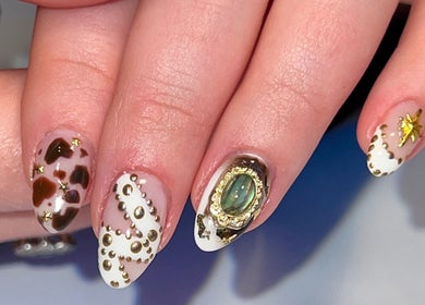 Elegant nail art at Jada Ellize Nails, London, England, GB, showcasing intricate designs and gemstones.