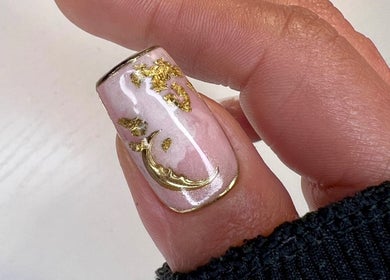 Close-up of a nail with gold crescent moon design at Jada Ellize Nails, London, England, GB.