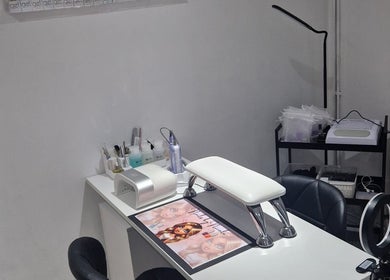 Nail station setup at Polished by Isobel in Oughtibridge, England, GB, showcasing manicure tools and equipment.