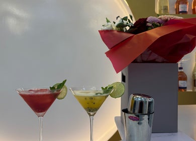 Elegant cocktails beside floral arrangement at Nailounge Hounslow, Hounslow, England, GB.
