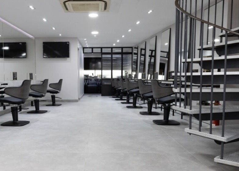 Spacious beauty salon at Contesse Aesthetics, Solihull, England, GB featuring sleek styling stations and mirrors.