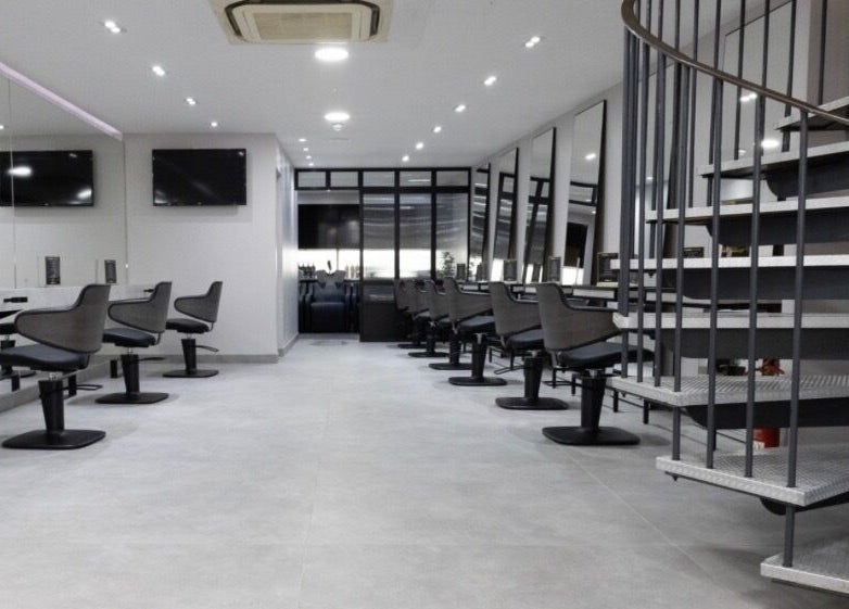 Spacious beauty salon at Contesse Aesthetics, Solihull, England, GB featuring sleek styling stations and mirrors.