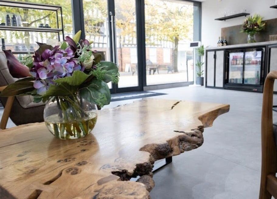 Beautiful rustic interior of Contesse Aesthetics, Solihull, England, GB, with a wooden table and floral decor.