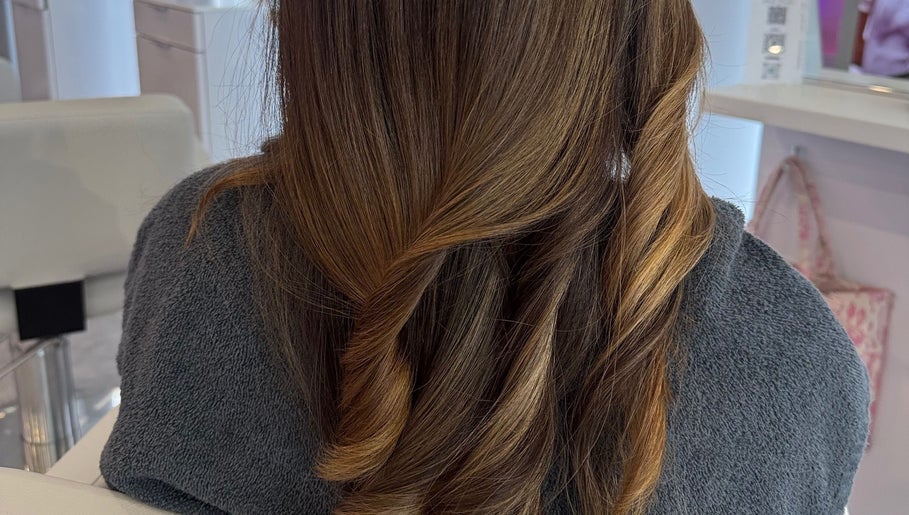 Stylish brunette curls at PrettybyMilli in Canton, Connecticut, US. A chic and sophisticated hairstyle.