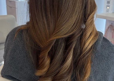 Stylish brunette curls at PrettybyMilli in Canton, Connecticut, US. A chic and sophisticated hairstyle.