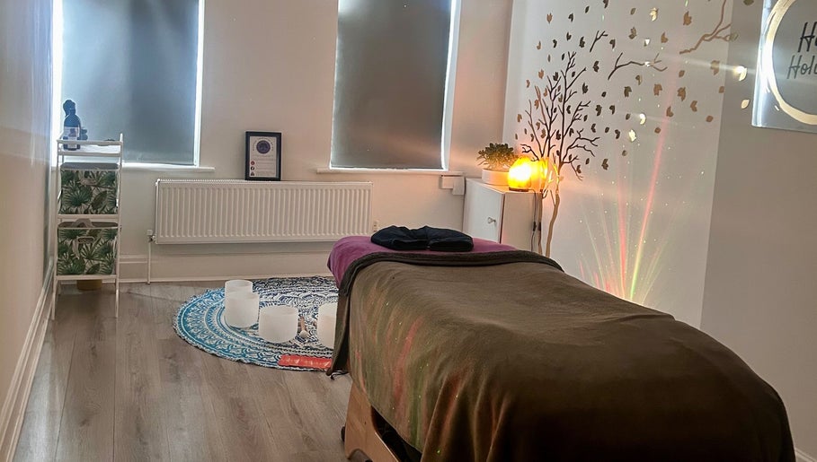 Relaxing therapy room at Rooted Therapies by Vic in Whiston, England, GB, with ambient lighting and calming decor.