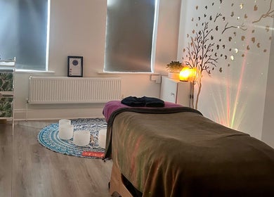 Relaxing therapy room at Rooted Therapies by Vic in Whiston, England, GB, with ambient lighting and calming decor.