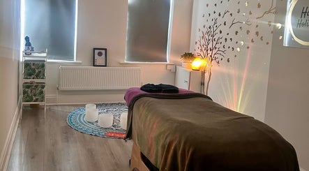 Relaxing therapy room at Rooted Therapies by Vic in Whiston, England, GB, with ambient lighting and calming decor.