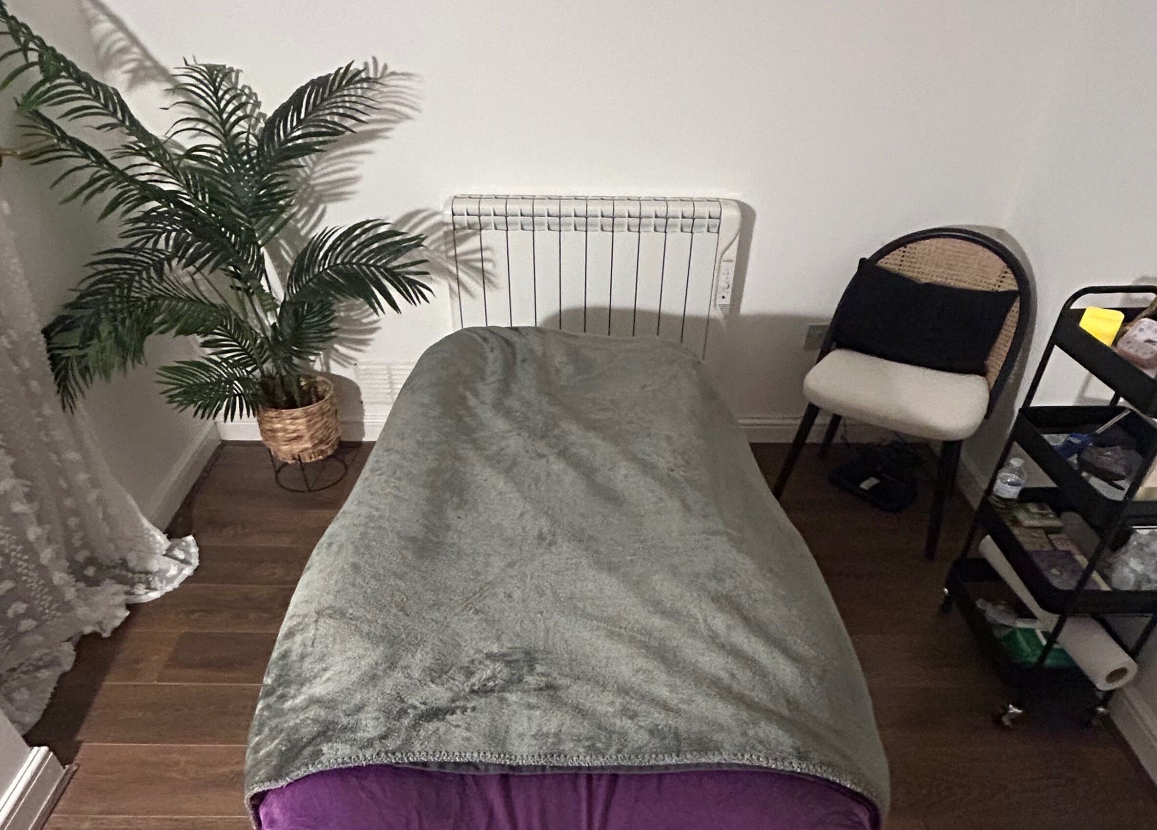 Cozy therapy room at Rooted Therapies by Vic at Bohemian Stars, Liverpool, England, GB with a massage bed and decor.