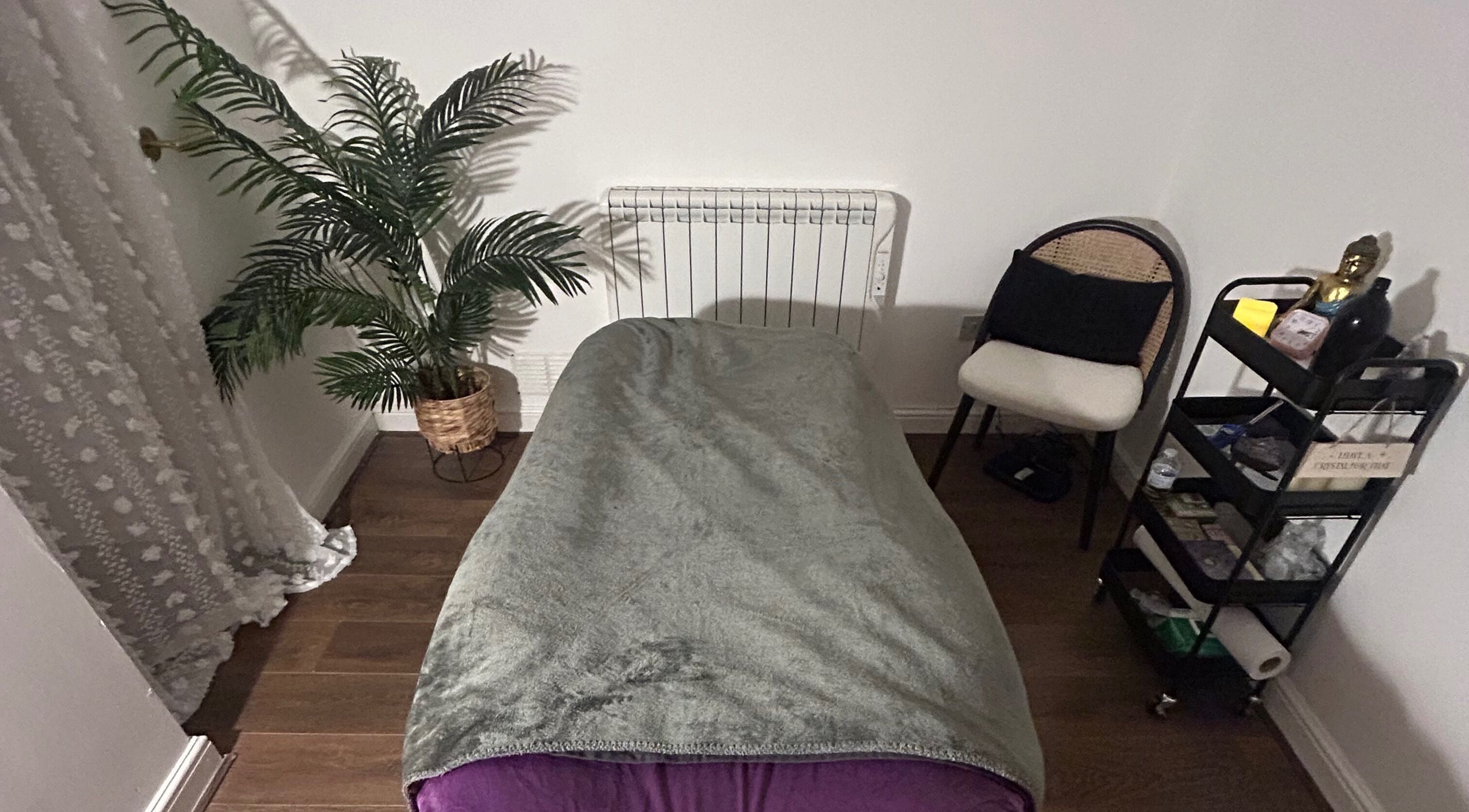 Cozy therapy room at Rooted Therapies by Vic at Bohemian Stars, Liverpool, England, GB with a massage bed and decor.