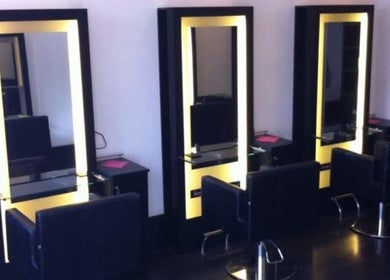 Elegant salon stations at Hair By Tamzin Louise, Stoke-on-Trent, England, GB with illuminated mirrors.