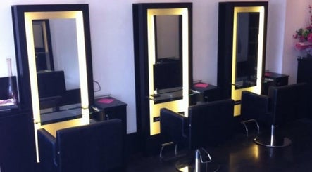 Elegant salon stations at Hair By Tamzin Louise, Stoke-on-Trent, England, GB with illuminated mirrors.