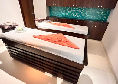 Relaxing spa room at Ojas Wellness Spa in Bengaluru, Karnataka, IN, featuring massage tables and serene decor.