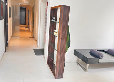 Sleek interior of Ojas Wellness Spa in Bengaluru, Karnataka with modern shelving and cozy furnishings.