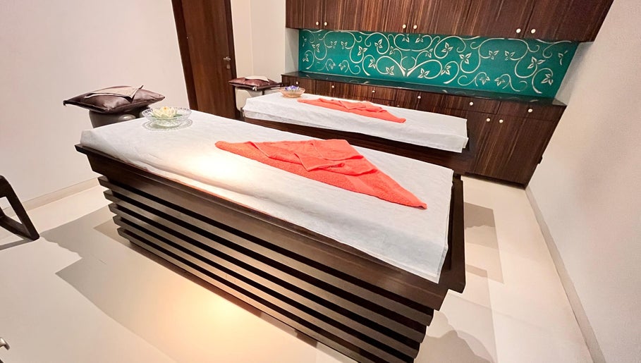Luxurious spa treatment room at Ojas Wellness Spa, Bengaluru, Karnataka, IN with elegant massage tables.