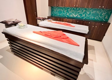 Luxurious spa treatment room at Ojas Wellness Spa, Bengaluru, Karnataka, IN with elegant massage tables.