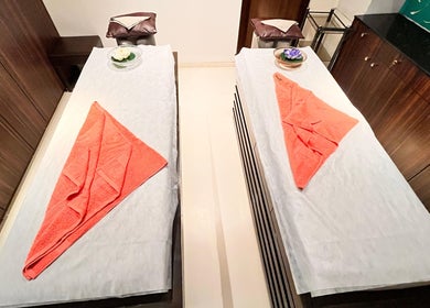 Relaxing twin massage beds at Ojas Wellness Spa, Bengaluru, Karnataka, IN, ready with plush towels.