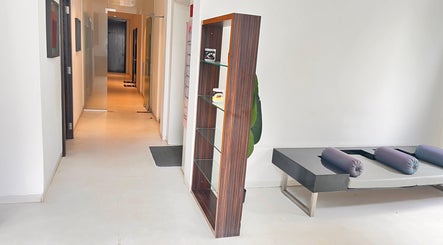 Serene hallway at Ojas wellness Spa in Bengaluru, Karnataka, IN, featuring modern decor and a relaxing atmosphere.