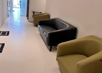 Comfortable seating area at Ojas Wellness Spa in Bengaluru, Karnataka, IN, with modern black and green chairs.