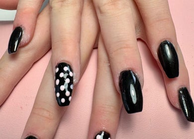 Elegant black nails with polka dots at Beauty by Zoe, Griffithstown, Wales, GB.