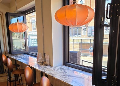 Chic seating in Remove Laser Clinic, Kimberley, England, GB with bright pendant lights and window views.