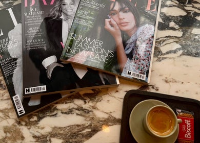 Marble table with magazines and coffee at Remove Laser Clinic, Kimberley, England, GB, offering a stylish vibe.