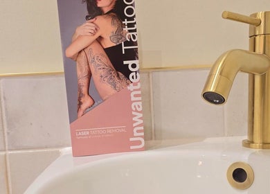 Promotional material for laser tattoo removal at Remove Laser Clinic in Kimberley, England, GB beside a gold tap.