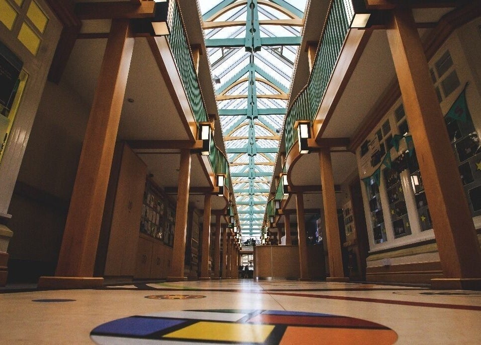 Elegant atrium interior at Back to Basics, Newton Aycliffe, England, GB. Modern wooden architecture and colorful floor.