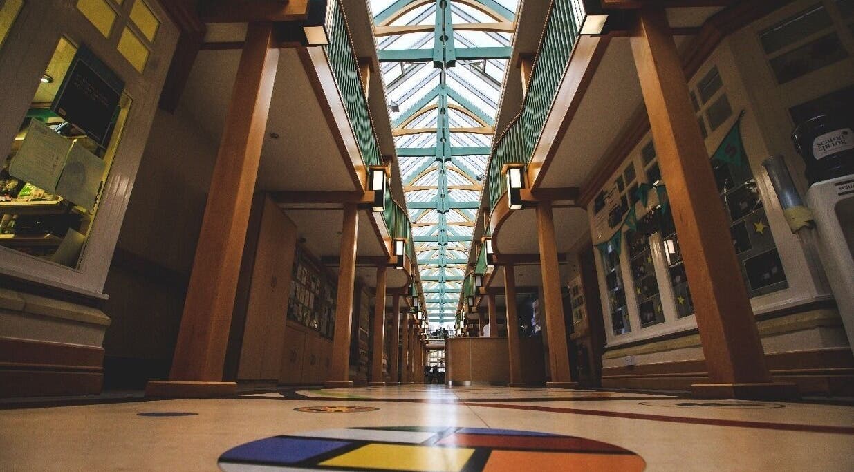 Elegant atrium interior at Back to Basics, Newton Aycliffe, England, GB. Modern wooden architecture and colorful floor.