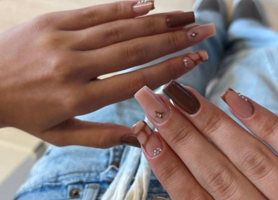 Chic nail art at Deni.xnails in București, RO showcasing stylish designs with gems on hands.