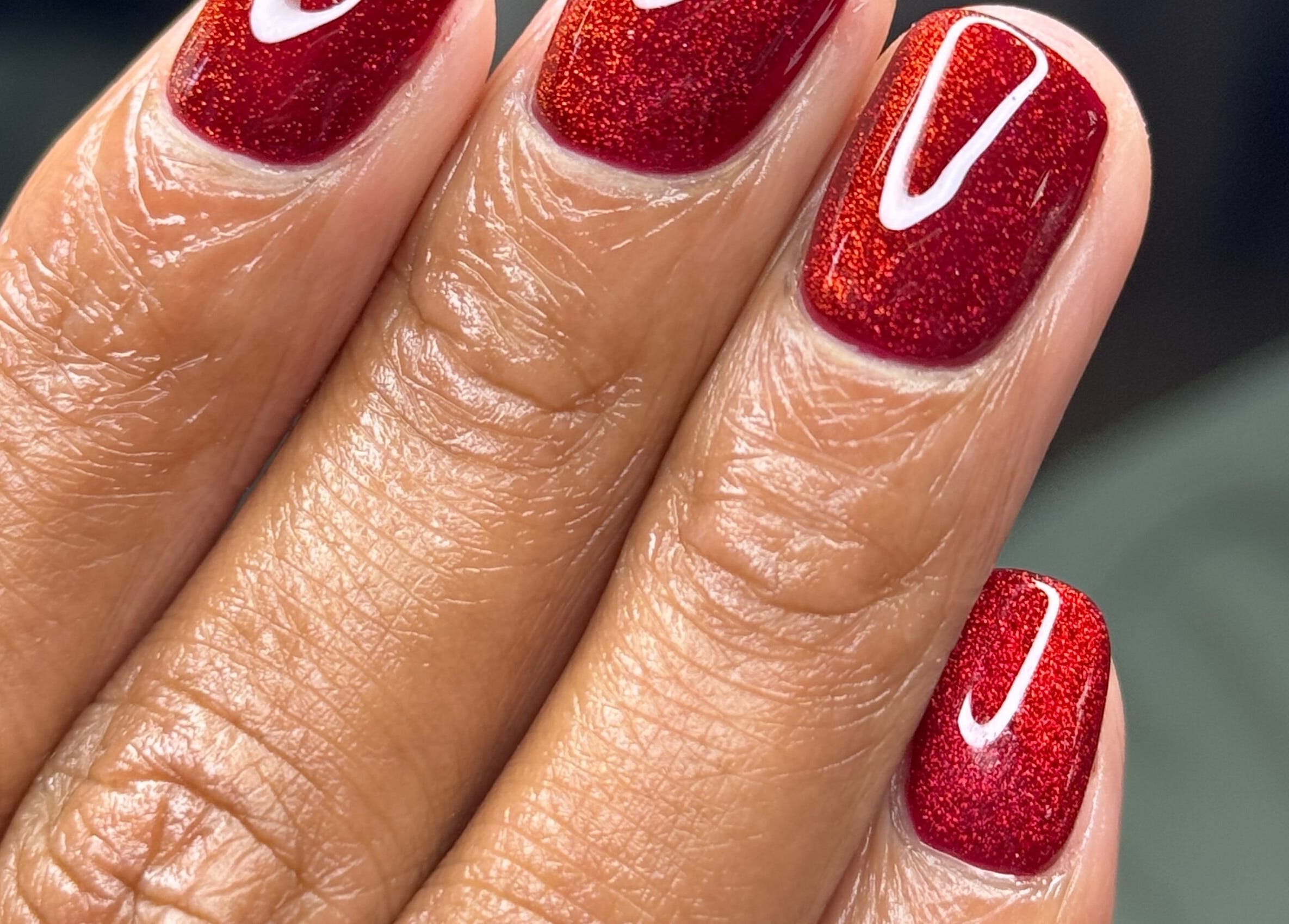 Elegant red nail art at Lesedi Naildit, Cape Town, Western Cape, ZA showcasing glossy finish and refined design.