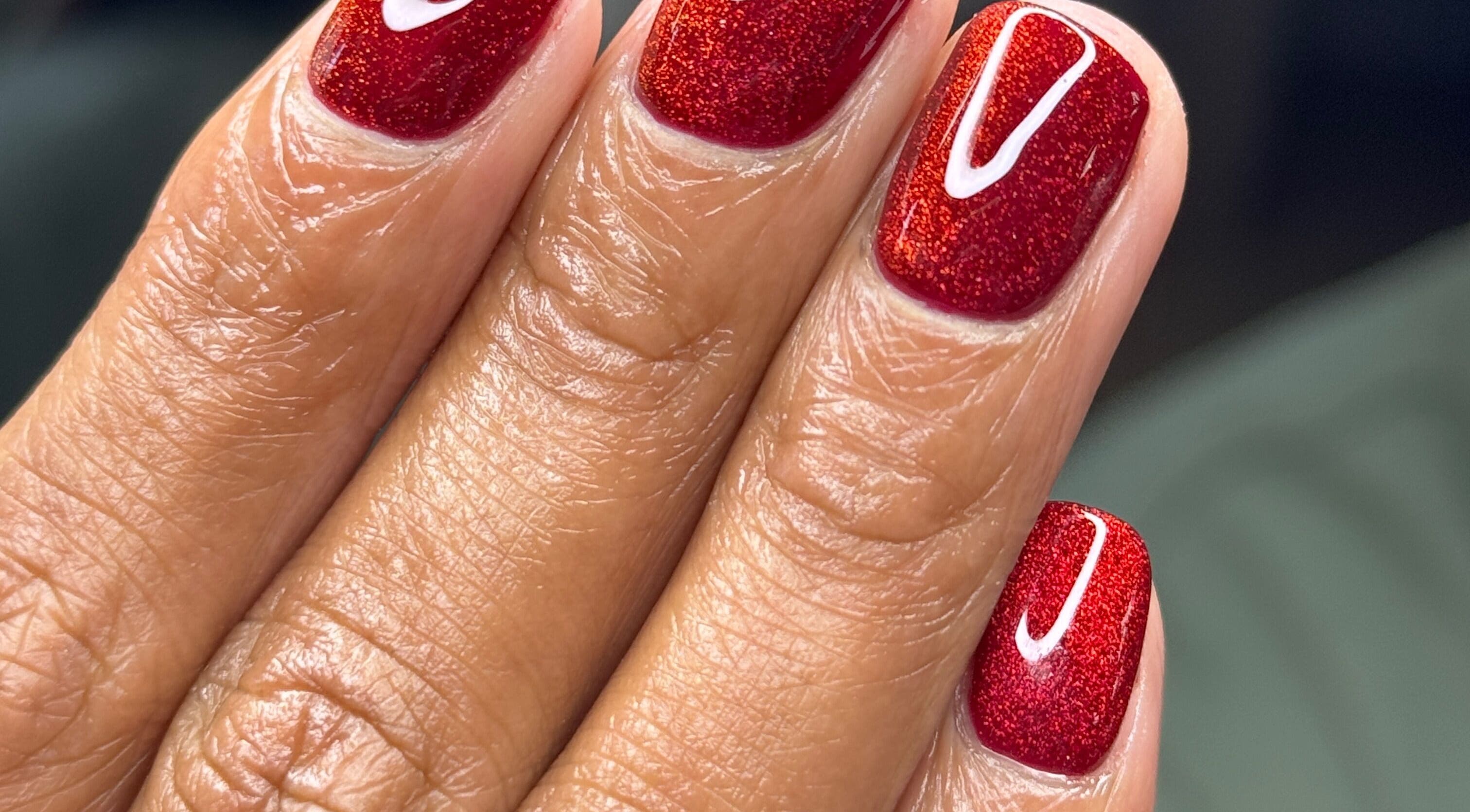 Elegant red nail art at Lesedi Naildit, Cape Town, Western Cape, ZA showcasing glossy finish and refined design.