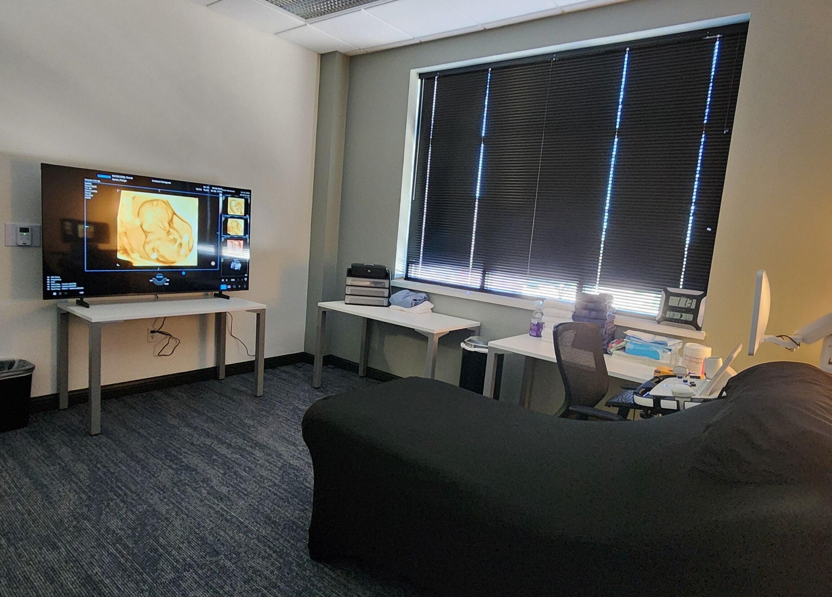 Modern sonogram room at Sunbeam Sonogram in De Pere, Wisconsin, US with cozy decor and advanced equipment.