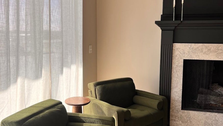 Elegant lounge with green chairs at Eyecandy Aesthetics, Seneca, South Carolina, US.