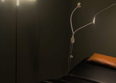 Cozy treatment room at Eyecandy Aesthetics, Seneca, South Carolina, US with ambient lighting and comfortable bed.
