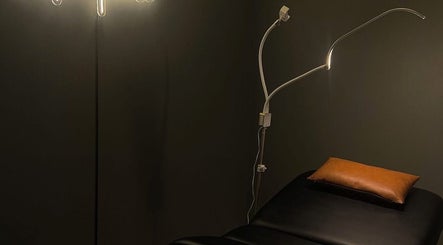 Cozy treatment room at Eyecandy Aesthetics, Seneca, South Carolina, US with ambient lighting and comfortable bed.